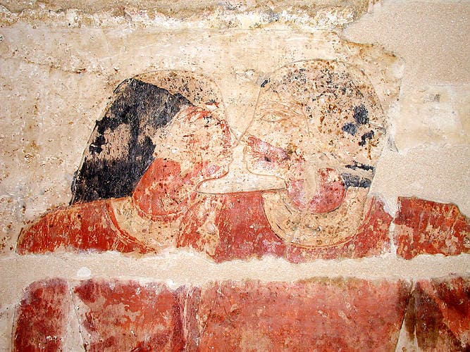 Two Egyptian men rubbing their noses