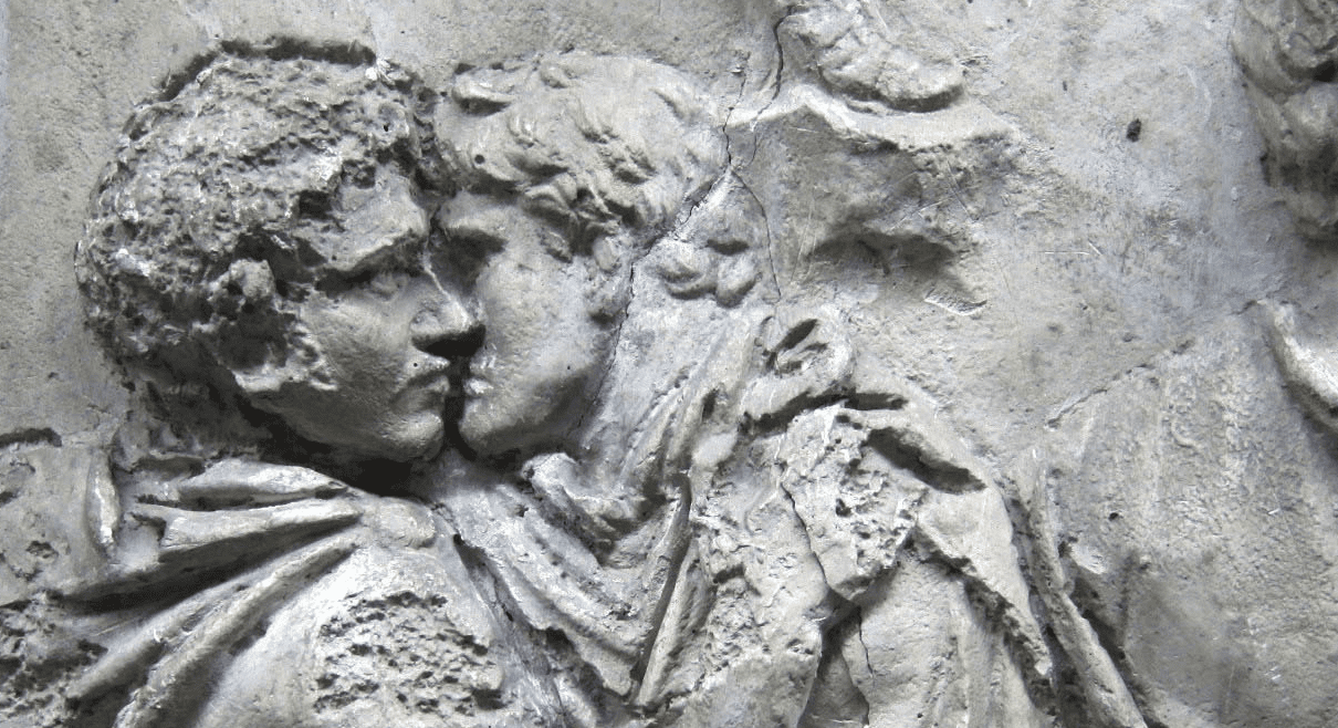 Stone relief of two Roman men kissing
