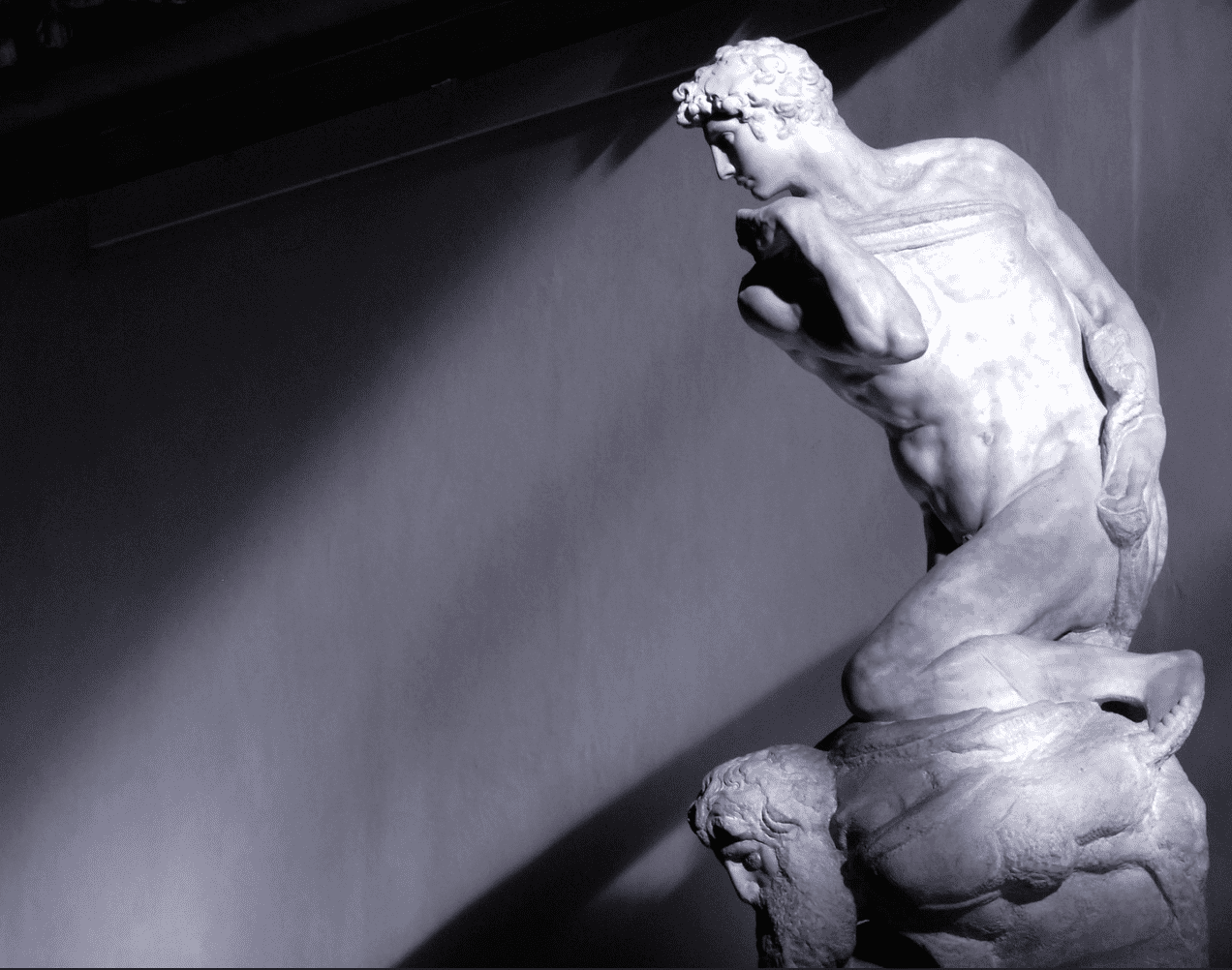 Sculpture of a young man kneeling over Michelangelo